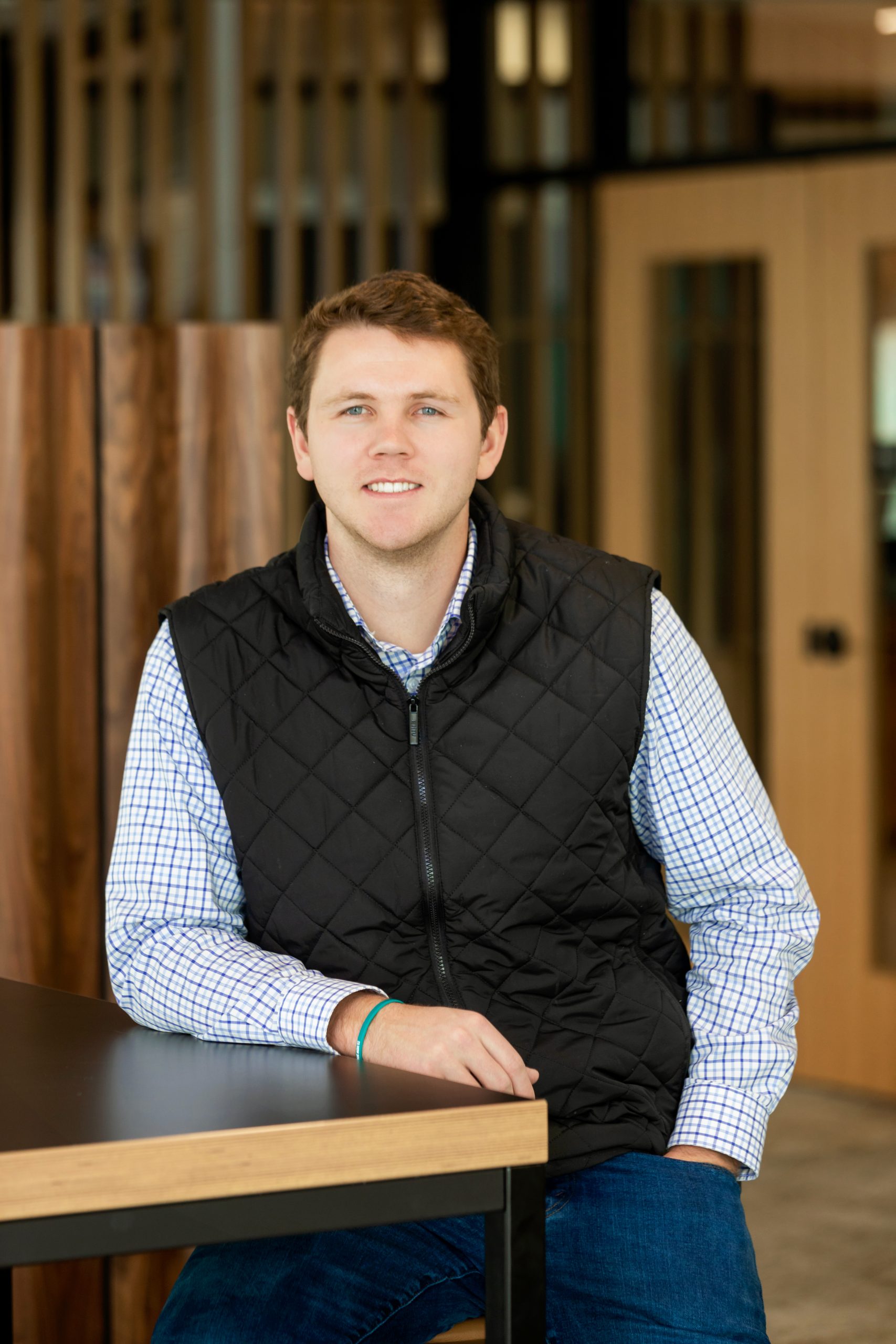 Founder sitting and smiling at table